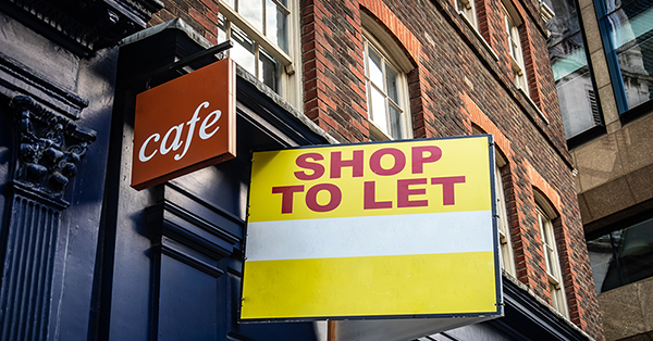 Commercial Rent Arrears Recovery explained by Parachute Law. A shop front on a red brick street displays a 'to let' sign.