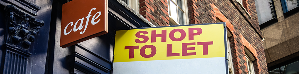 Commercial Rent Arrears Recovery explained by Parachute Law. A shop front on a red brick street displays a 'to let' sign.