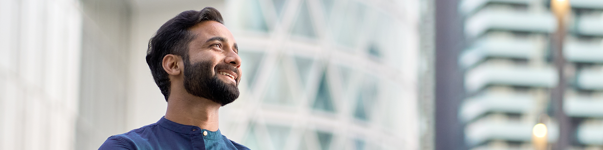 A man smiles out over the city, having finalised his Directors Loan Agreement from Parachute Law