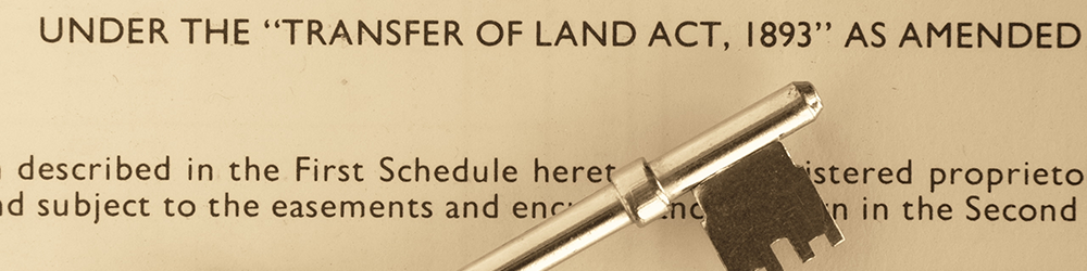 Door key resting on title certificate of a house. Parachute Law Solicitors explains restrictions beginning with 'no disposition of the registered estate'